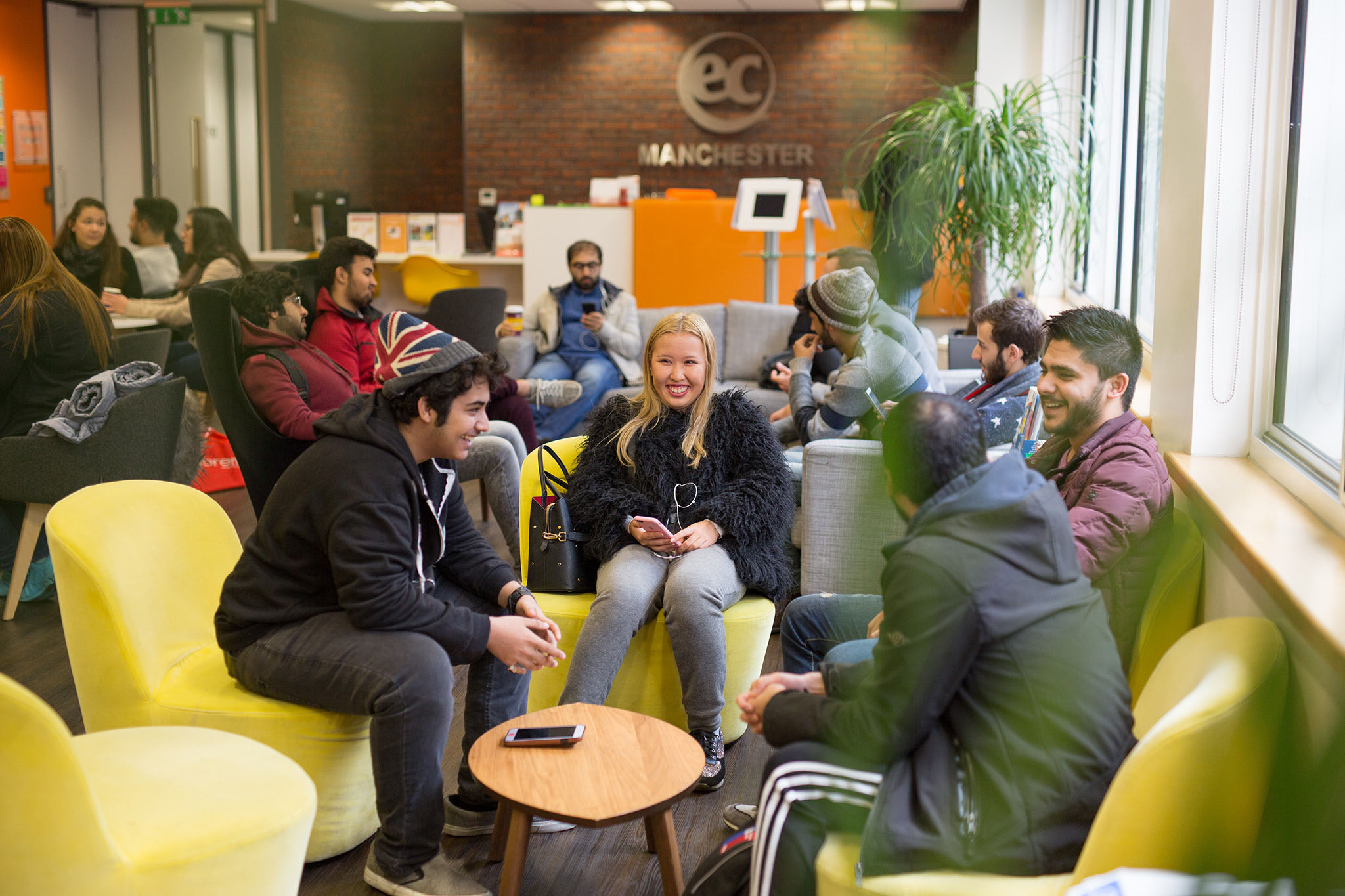 English School in Manchester - EC Language School | ESL. Students Studying and having a good time in EC Manchester Lobby