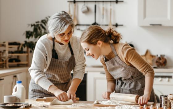 two persons cooking together at home